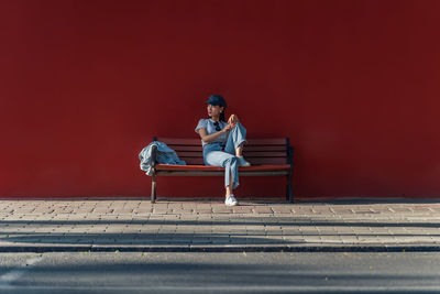 Rear view of man sitting on road