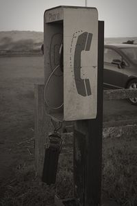 Close-up of abandoned telephone on field
