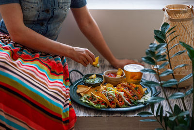 Midsection of woman preparing food on table