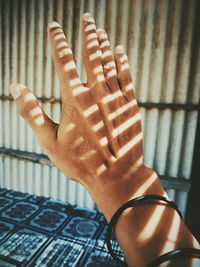 Close-up of person hand against wall