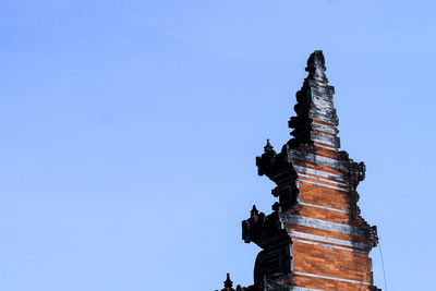 Low angle view of ancient temple against blue sky