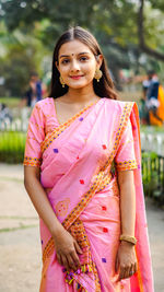 Portrait of a smiling young woman standing outdoors