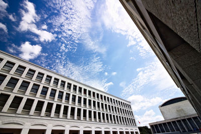 Low angle view of buildings against cloudy sky