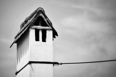 Low angle view of old wooden house against sky