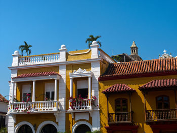 Low angle view of building against clear blue sky