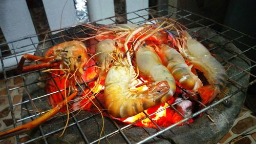 High angle view of meat on barbecue grill