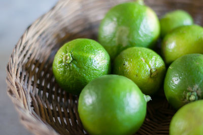 Close-up of green fruits in basket on table