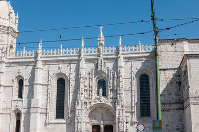 Low angle view of historic building against blue sky