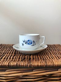 Close-up of coffee cup on table against wall