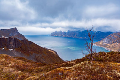 Scenic view of sea and mountains against sky