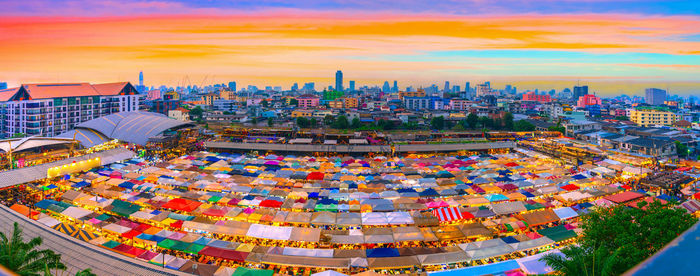 High angle view of illuminated buildings against sky during sunset