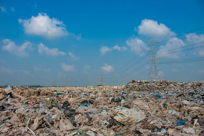 Stack of garbage against blue sky