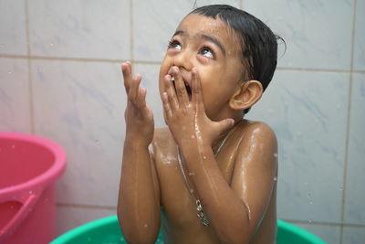 Portrait of shirtless water in sink