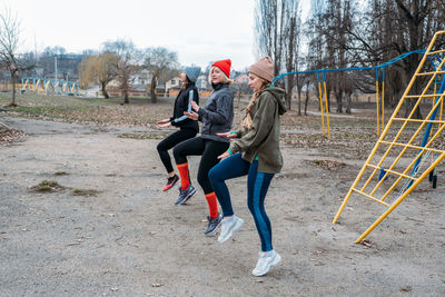 Female friends exercising in park