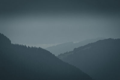 Scenic view of silhouette mountains against sky