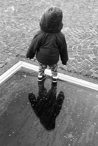 Rear view of boy on water