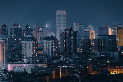 Illuminated buildings in city at night