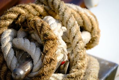 Close-up of rope rolled bollard at harbor