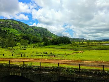 Scenic view of agricultural field against sky