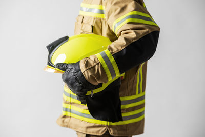 Man working against yellow background