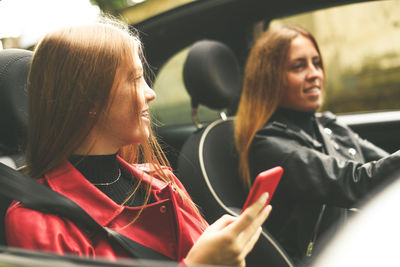 Friends talking to each other in car