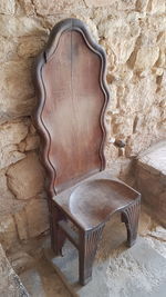 Empty chair against wall at home