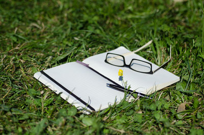 High angle view of open book on field