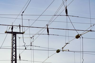 Low angle view of electricity pylon against sky