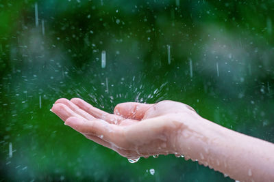 Cropped hand of woman holding water