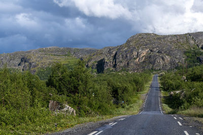 Road amidst mountains against sky