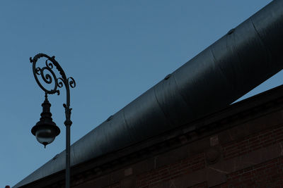 Low angle view of street light against building