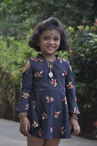 Portrait of smiling girl standing outdoors