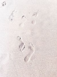 High angle view of footprints on sand