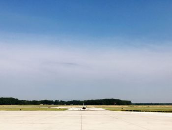 Airplane on runway against clear sky