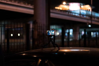 Mobile phone attached to stand on car