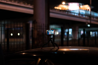Smart phone with tripod on car at night