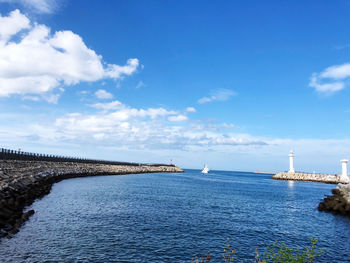 Scenic view of bay against blue sky