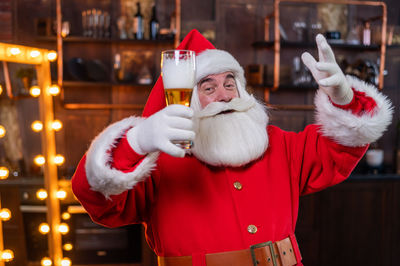 Portrait of santa clause holding beer glass