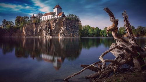 Scenic view of lake by building against sky