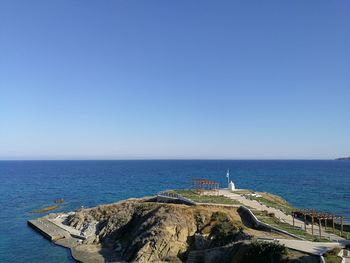 Scenic view of sea against clear blue sky