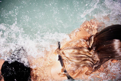 Close-up of woman splashing water