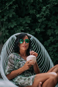 Portrait of young woman sitting outdoors