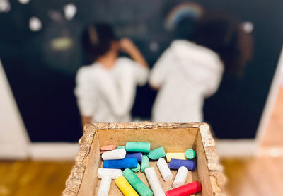 Close-up of multi colored chalks in container