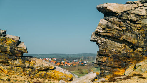 Rock formations on mountain against clear sky