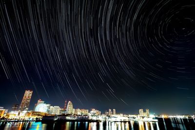 Illuminated buildings against sky at night