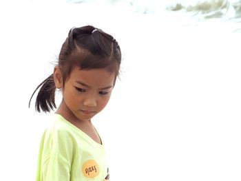 Portrait of girl standing against white background