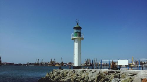 Lighthouse against clear blue sky