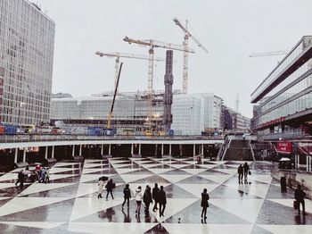 High angle view of people walking by buildings in city