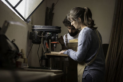 Side view of woman working