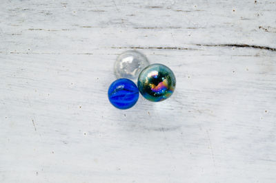 Directly above shot of marbles on wooden table